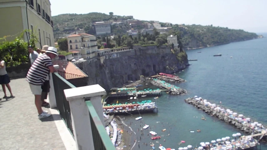 a man on top of a balcony looking over a harbor