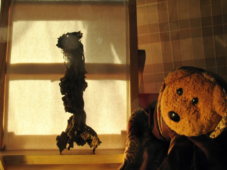 a teddy bear sitting on top of a wooden table