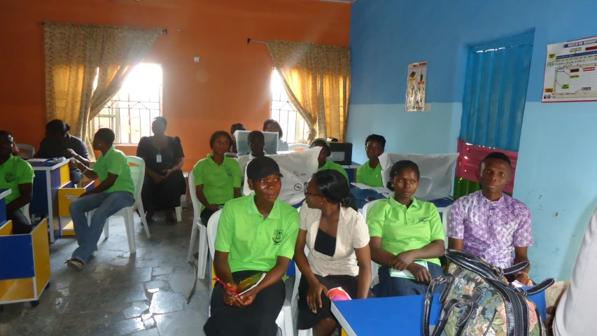 a classroom full of people sitting on chairs