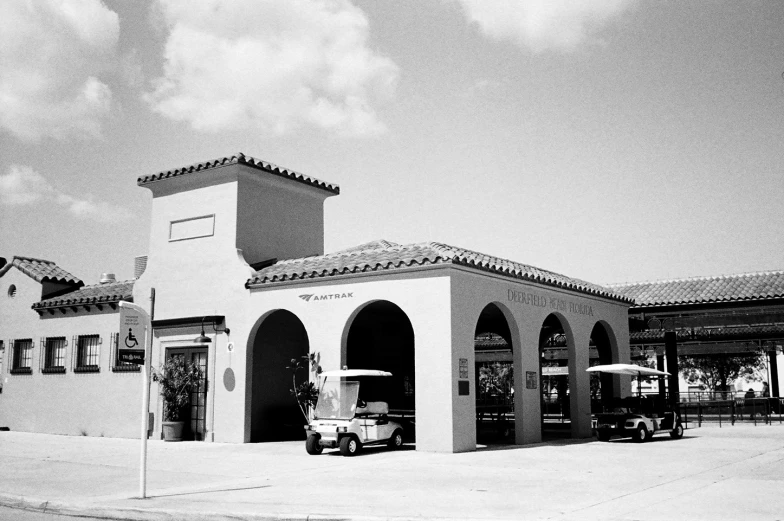 a black and white po of a building and car