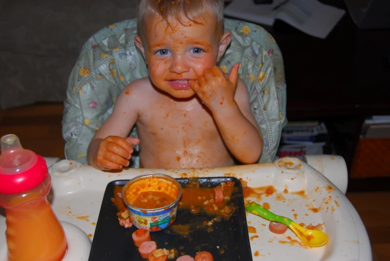a baby in a high chair eating food