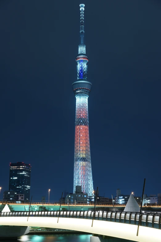 a city skyline with the sky line and tower illuminated at night