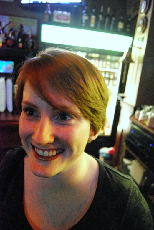 a woman smiling with very small teeth and a black shirt