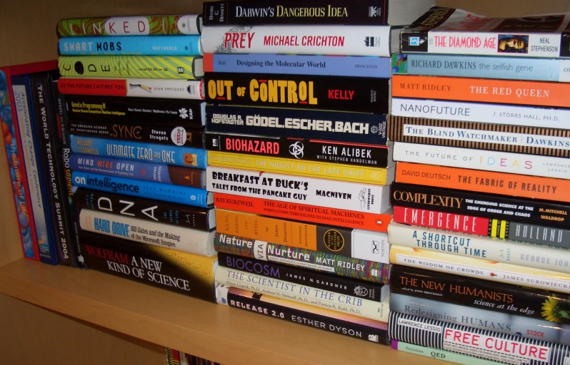 a book shelf with books stacked on it