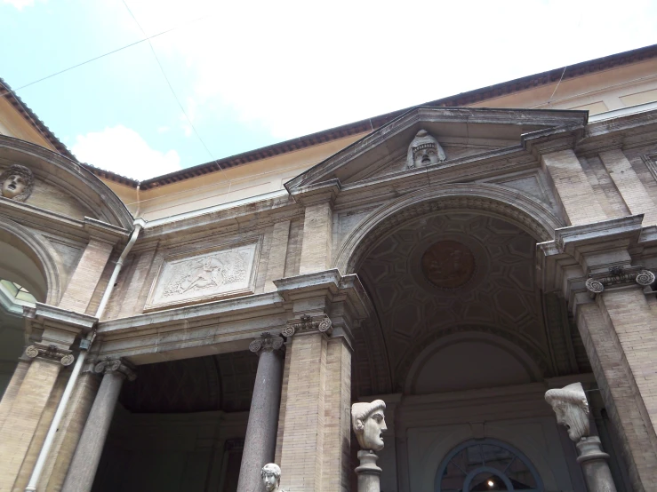 the front entrance to an old building with marble carvings