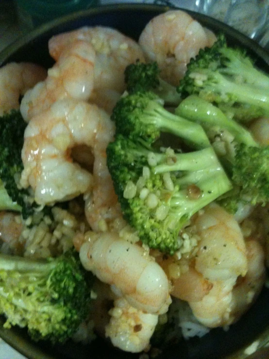 the shrimp and broccoli are fried with sesame seeds