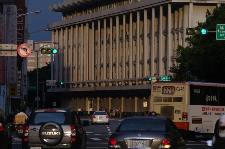 traffic at an intersection near large buildings in an asian city