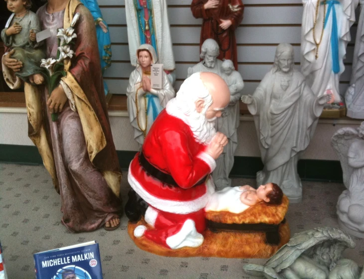 a statue of a santa putting money into a bag