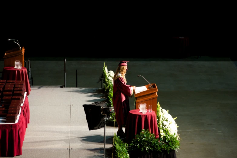 an image of a woman at the podium with two other microphones