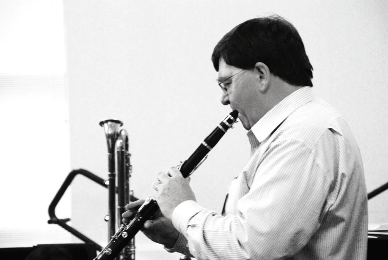 a man playing on a saxophone and band instruments