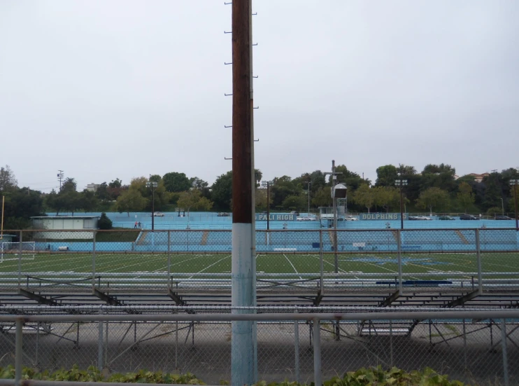 several rows of seats sit behind a fence