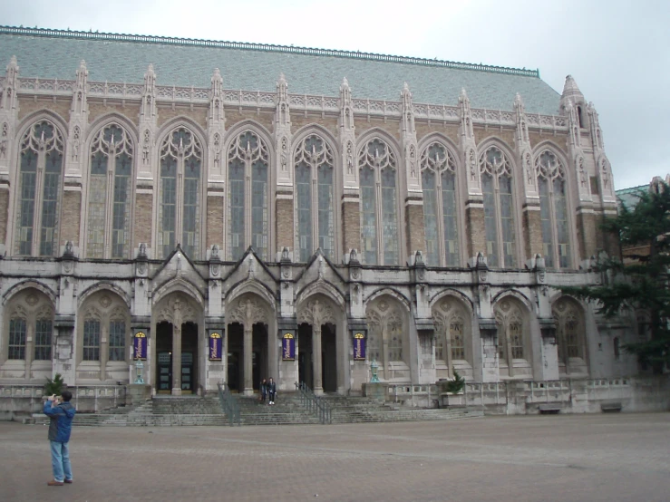 a building with two people standing outside in front of it