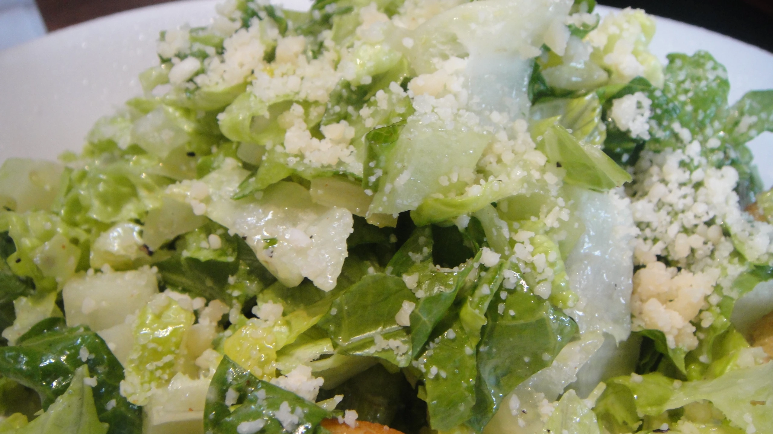 a white plate topped with salad covered in broccoli