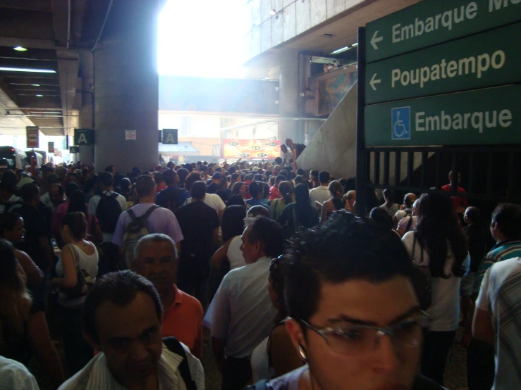 a large crowd is gathered to look at information