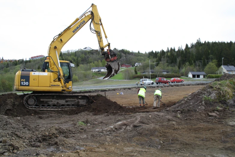 two workers working in the dirt on a construction project