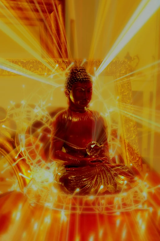 a person sitting on a buddha statue with light shining through it