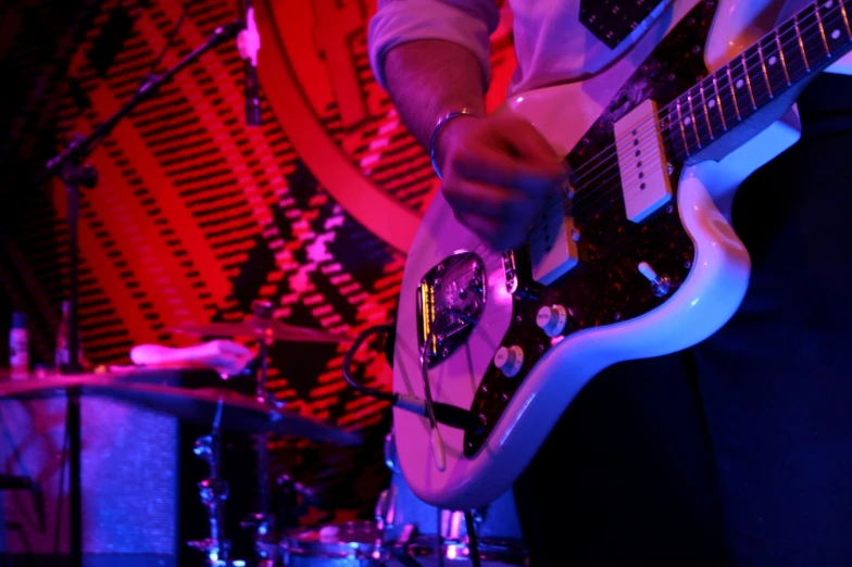 a man is playing a guitar on stage