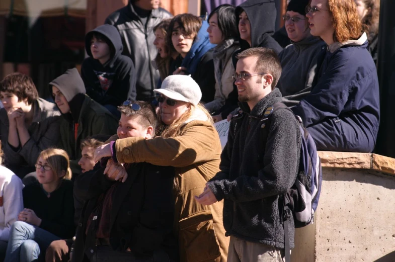 group of people standing in front of a crowd of people