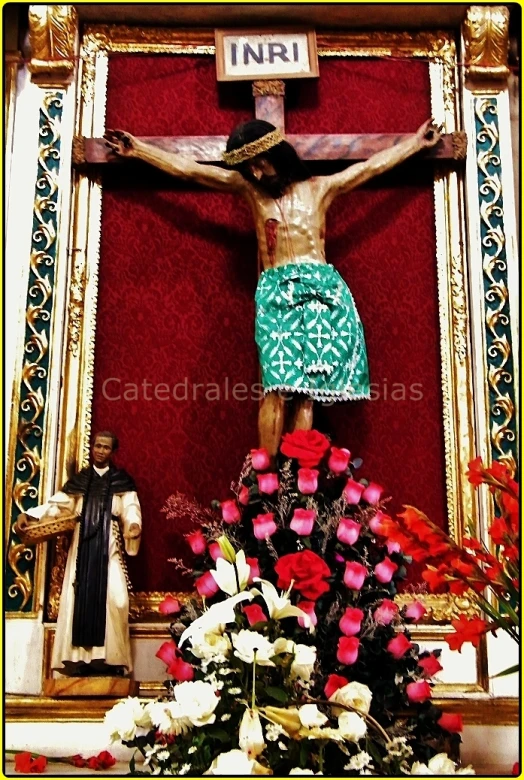 the crucifix with flowers on a red carpet
