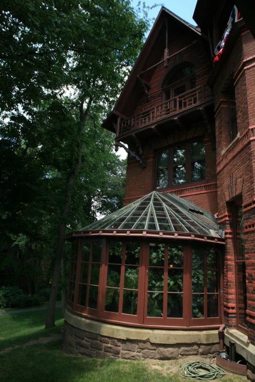 a red brick house with a glass gazebo