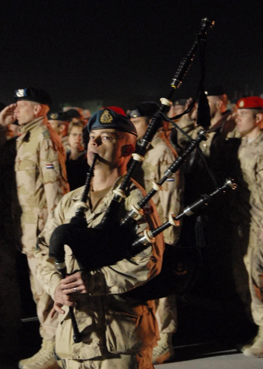 a group of soldiers wearing uniform and carrying musical instruments