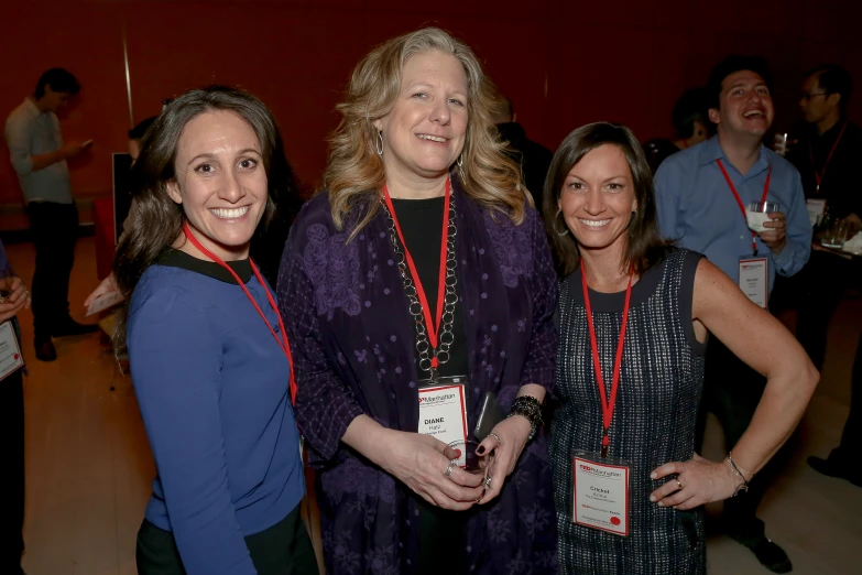 three women in front of a group of others