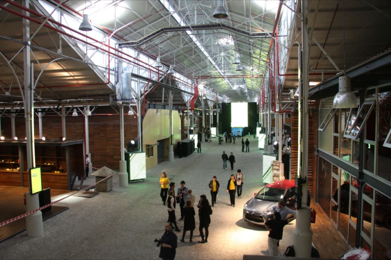 people standing around an indoor facility with open windows