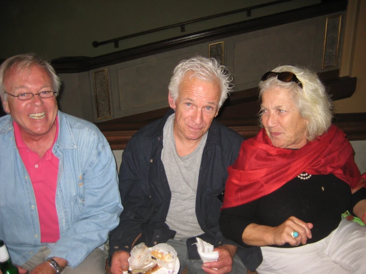 two men and a woman sitting next to each other