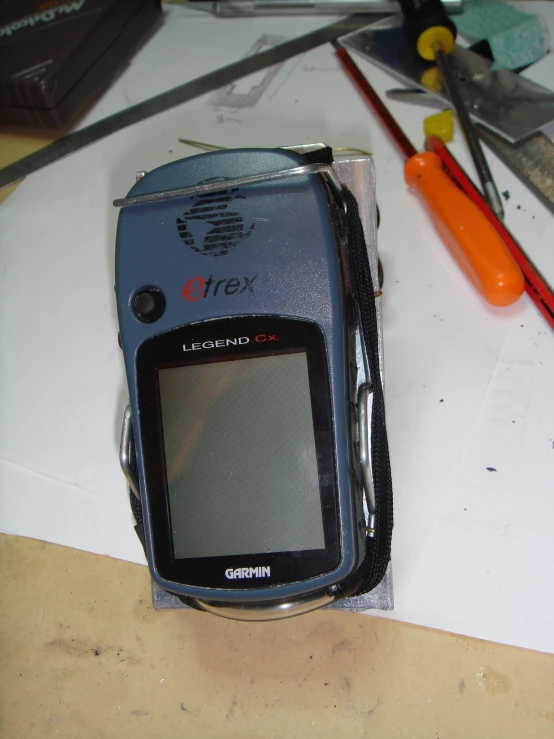 a close up of a cell phone with scissors and a knife