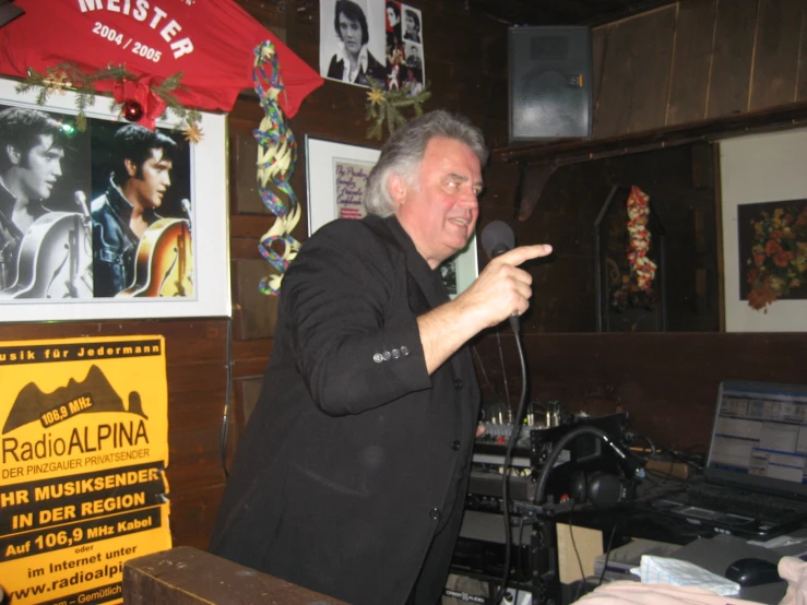 a man pointing to soing in front of a computer