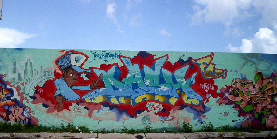 a wall with many graffiti written on it