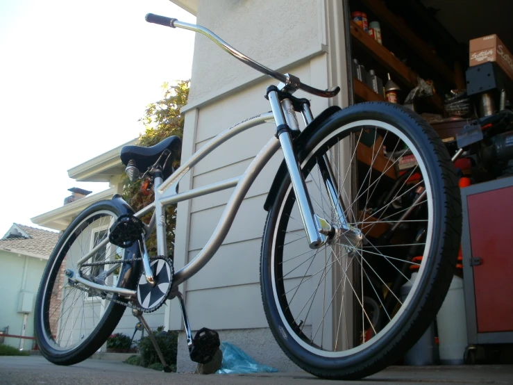 an old bike leans against a garage door