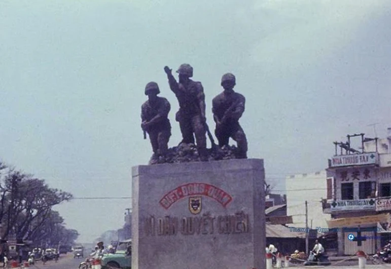 a group of soldiers on top of a small statue in the middle of a street