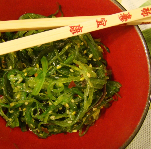 the bowl holds chopped greens, and chopsticks