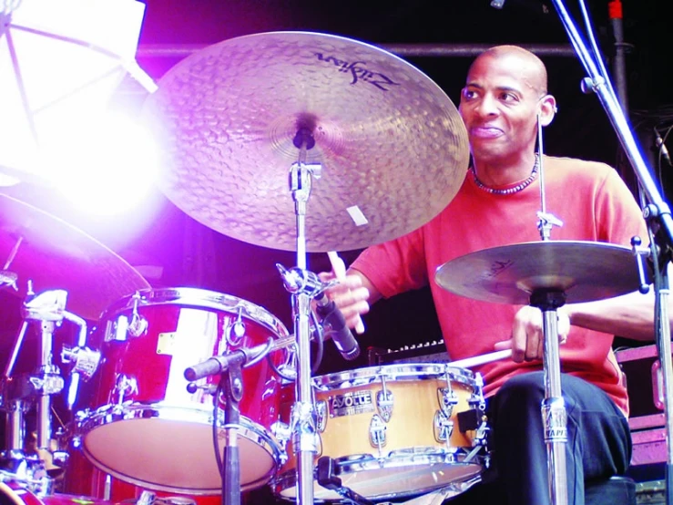 a man sitting on top of a drum kit