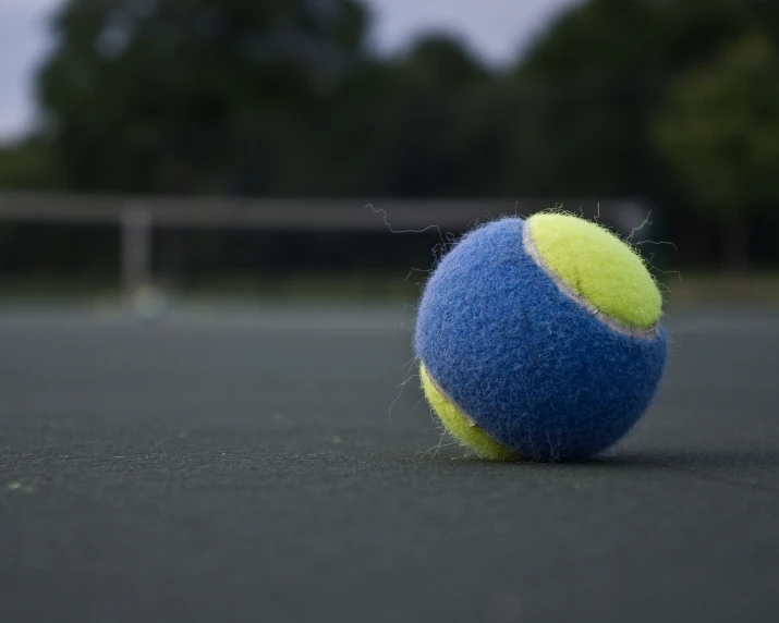 tennis ball on the tennis court in front of a net