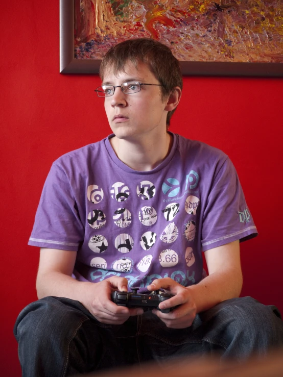 young man in purple shirt playing video games