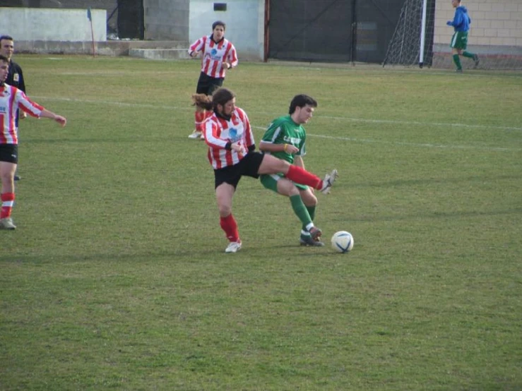 a soccer game is being played on a green field