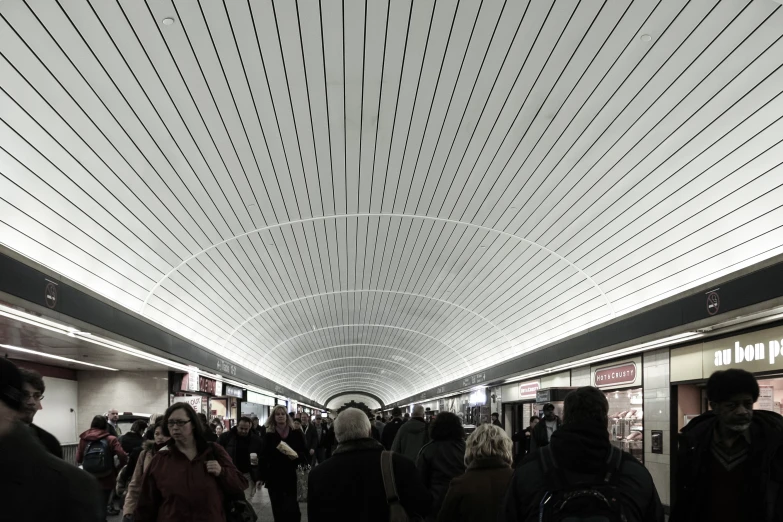 many people walk together and in the train station