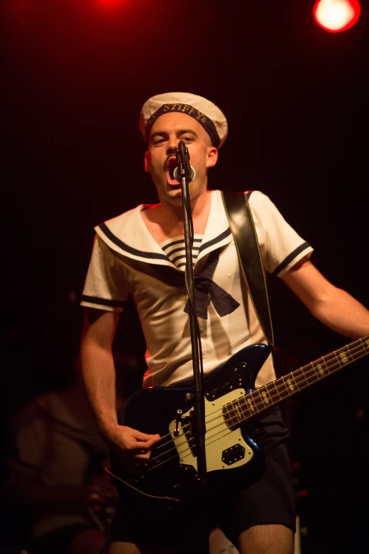 a male with a guitar and some lights