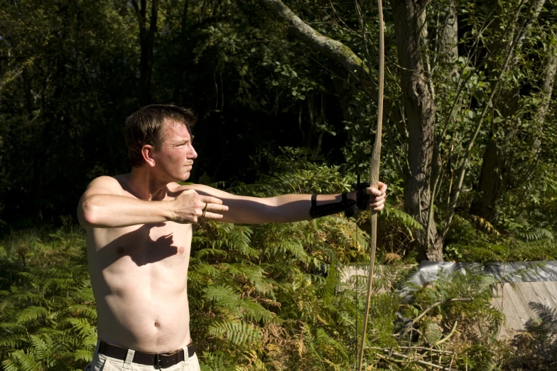 man in shorts posing for the camera holding soing