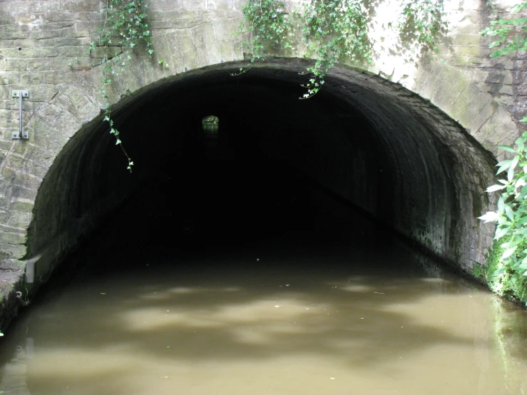 a view of a tunnel entrance with a water way through it