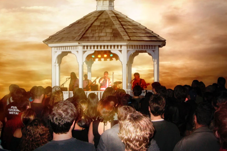 group of people standing around in front of a gazebo