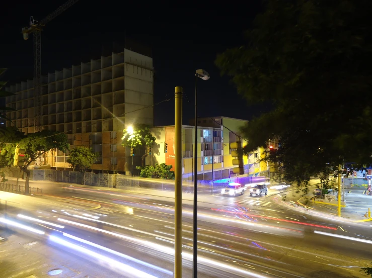 a city street at night with buildings and traffic on it