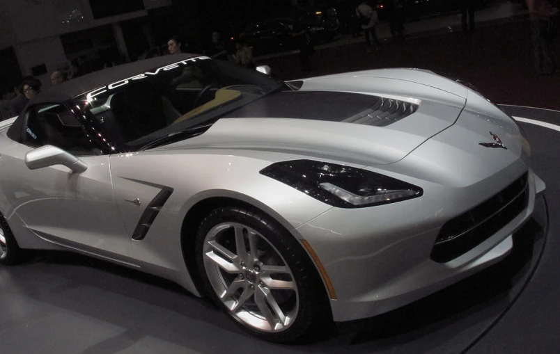 silver chevrolet sports car on display at an event