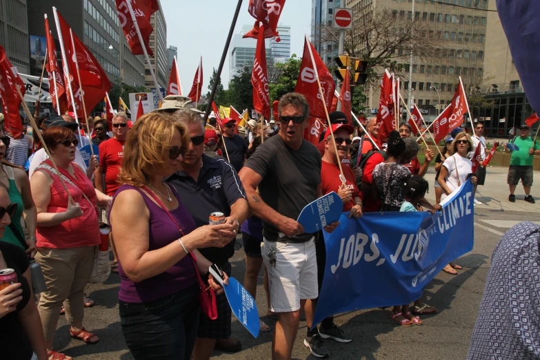 group of people with flags walking down the street