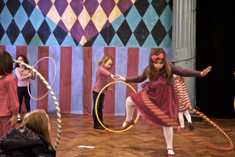 two s playing with a hoop and ribbons