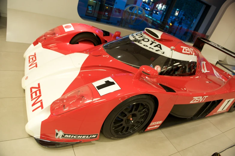 a very nice race car in a showroom