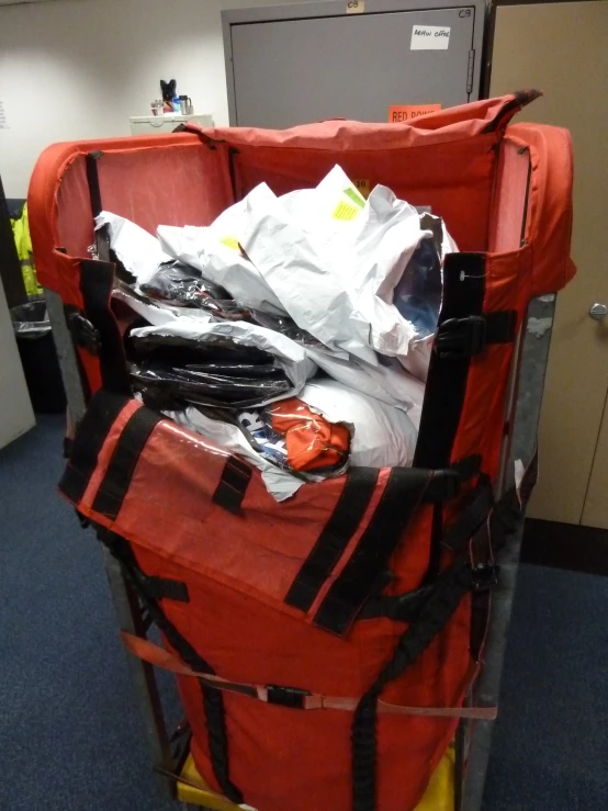 luggage and supplies piled up in an office room