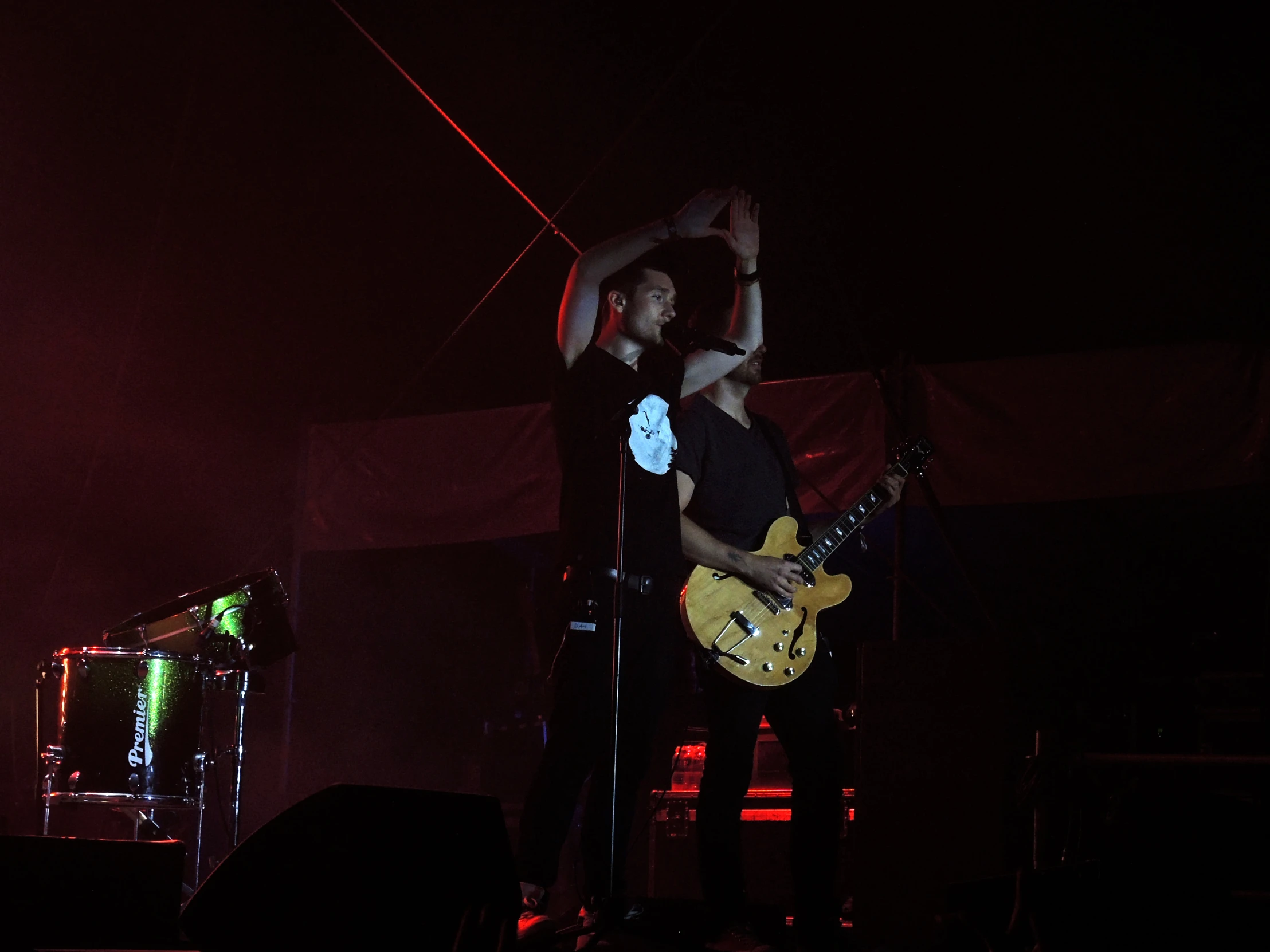 two men holding up their arms on stage